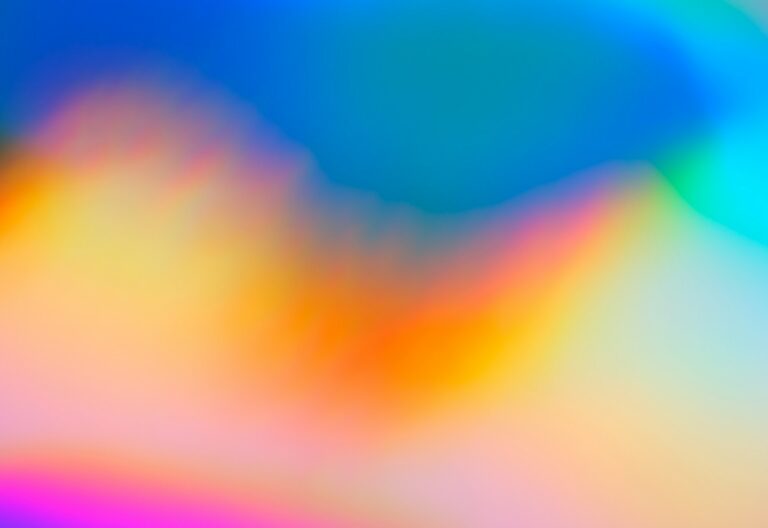 a blurry image of a rainbow colored background
